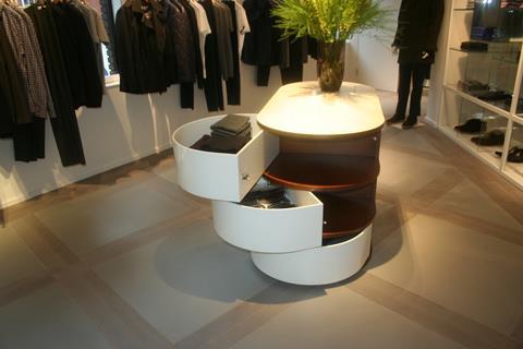 Mid-shop curved white tables that pivot to open and a statement-piece bench catch the eye